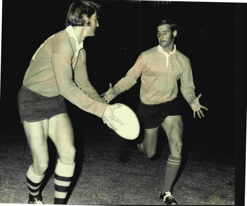 two men are playing rugby and one has the number 5 on his shirt