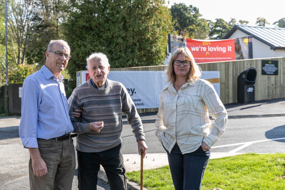 Peter Laidler (left), 70, dad Cyril Taylor, 91, and Rachel photographed with the banner saying she is ‘not loving’ a new McDonald’s