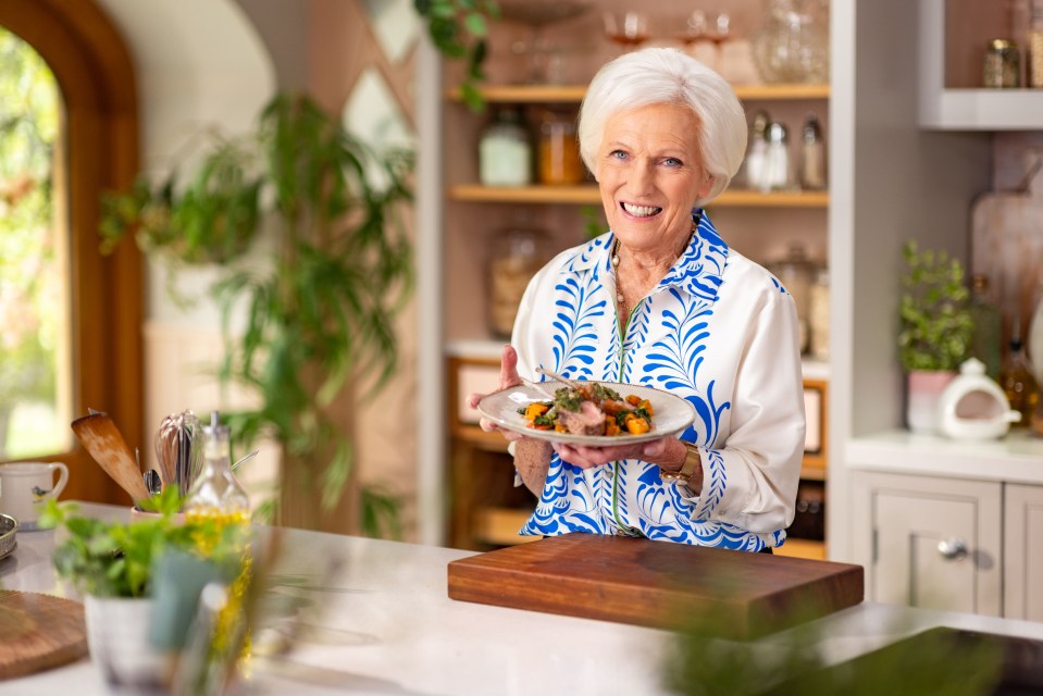 a woman in a blue and white shirt is holding a plate of food