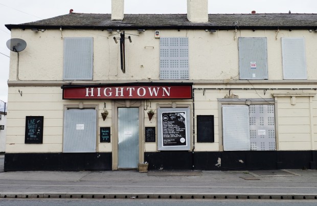 a white building with a red sign that says hightown