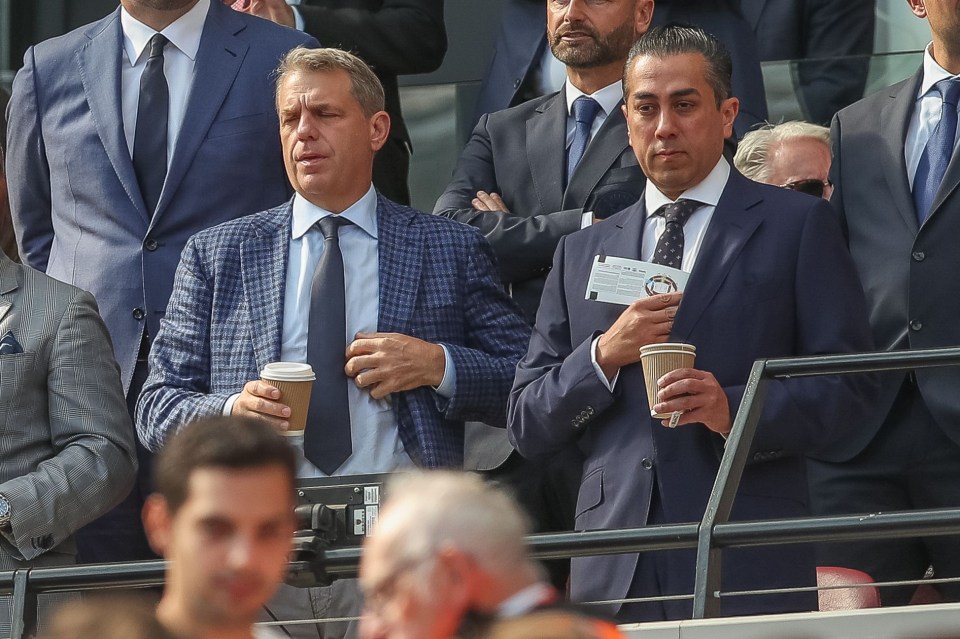 a man in a suit and tie is holding a cup of coffee