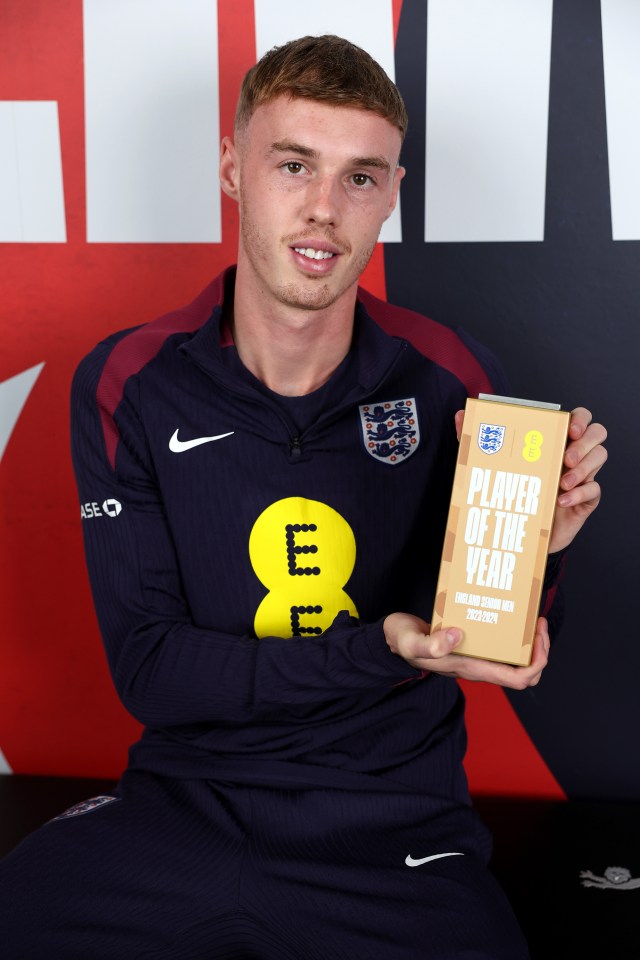 a man holding a player of the year plaque