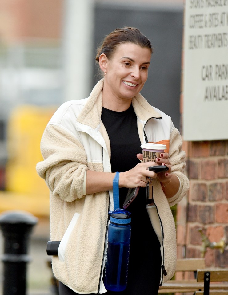 a woman holding a cup that says hulk on it