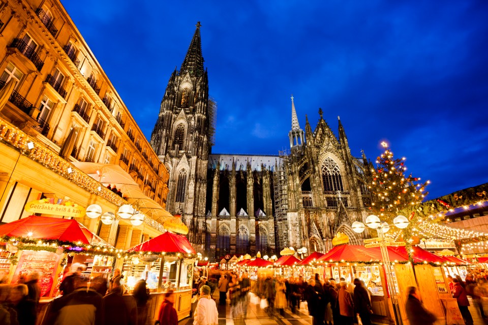 a christmas market in front of the cologne cathedral