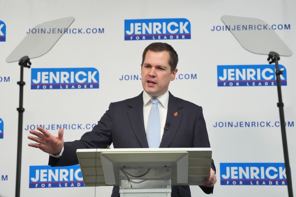 a man stands at a podium in front of a sign that says join jenrick for leader