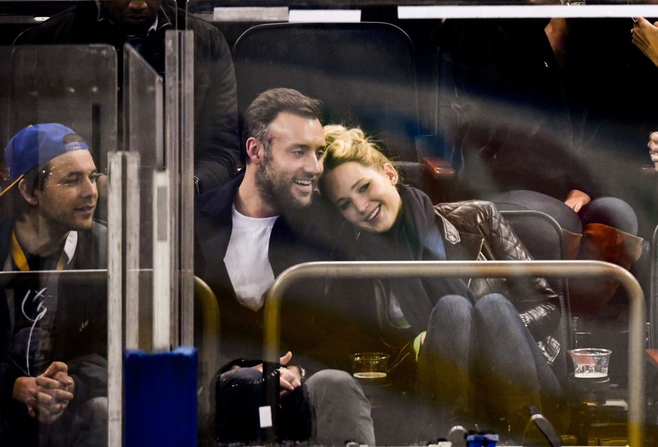 a man and a woman are sitting in the stands at a hockey game