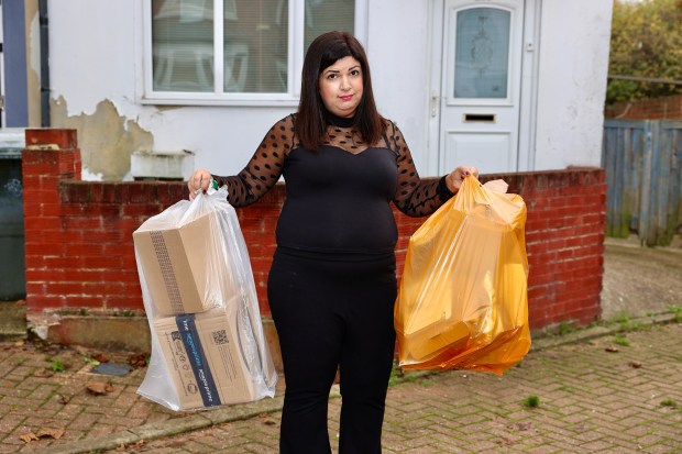 a woman holding a box that says amazon on it