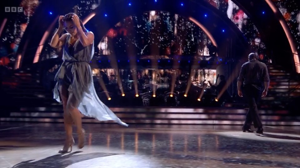 a man and a woman are dancing on a stage with bbc written on the bottom