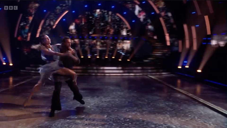 a couple dancing on a stage with bbc written on the bottom