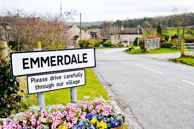 a sign that says &quot; please drive carefully through our village &quot;