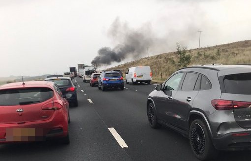 a mercedes benz suv is driving down a highway