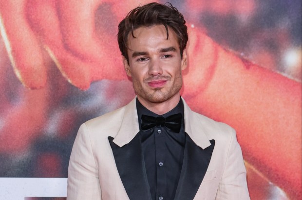 a man in a white suit and black bow tie