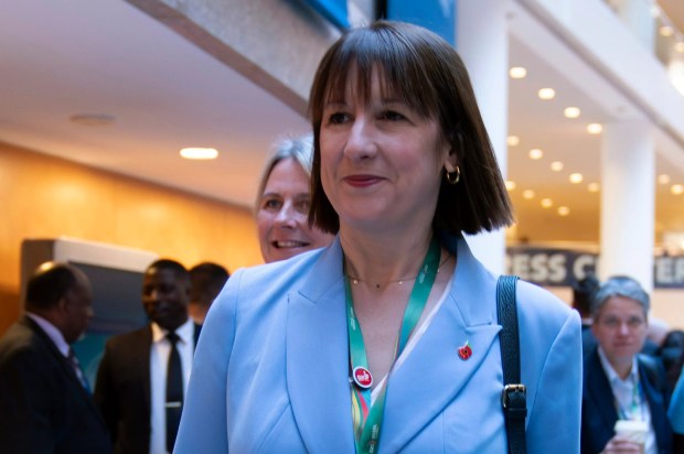 a woman in a blue suit has a name tag that says ' elizabeth johnson ' on it