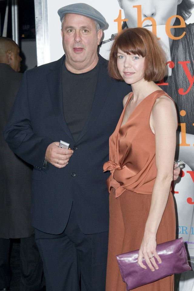 a man and a woman standing in front of a sign that says the y