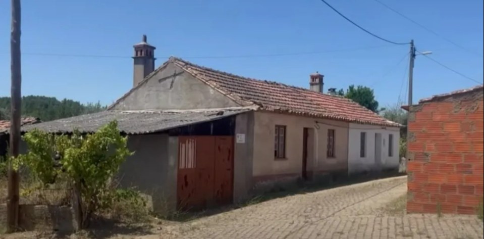 a house with a cross on the side of it