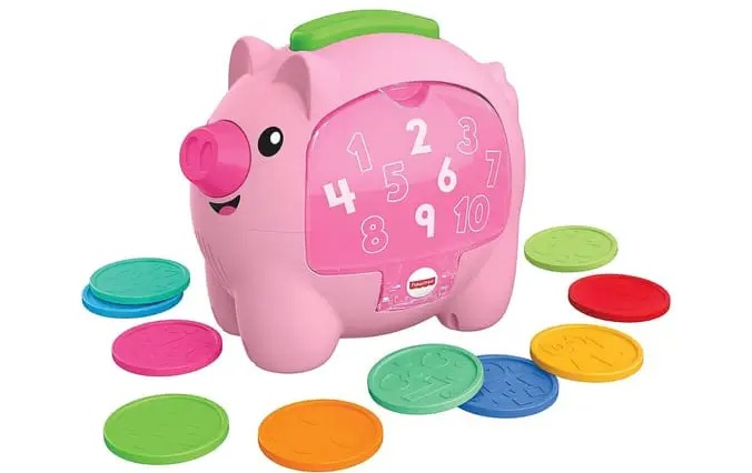 a pink piggy bank with coins and numbers on it