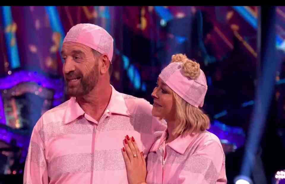 a man and a woman wearing pink pajamas and hats