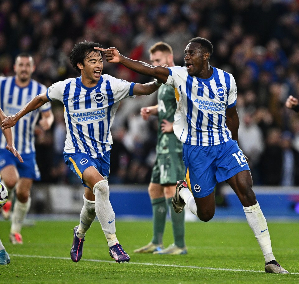 two soccer players wearing american express jerseys celebrate a goal