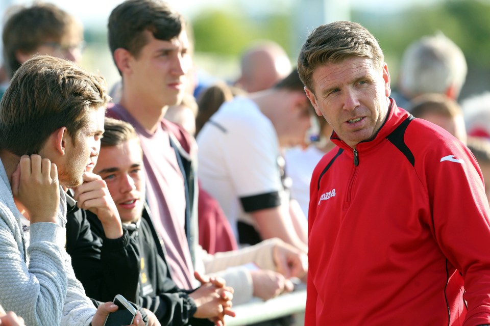 a man wearing a red jacket with the word jako on it