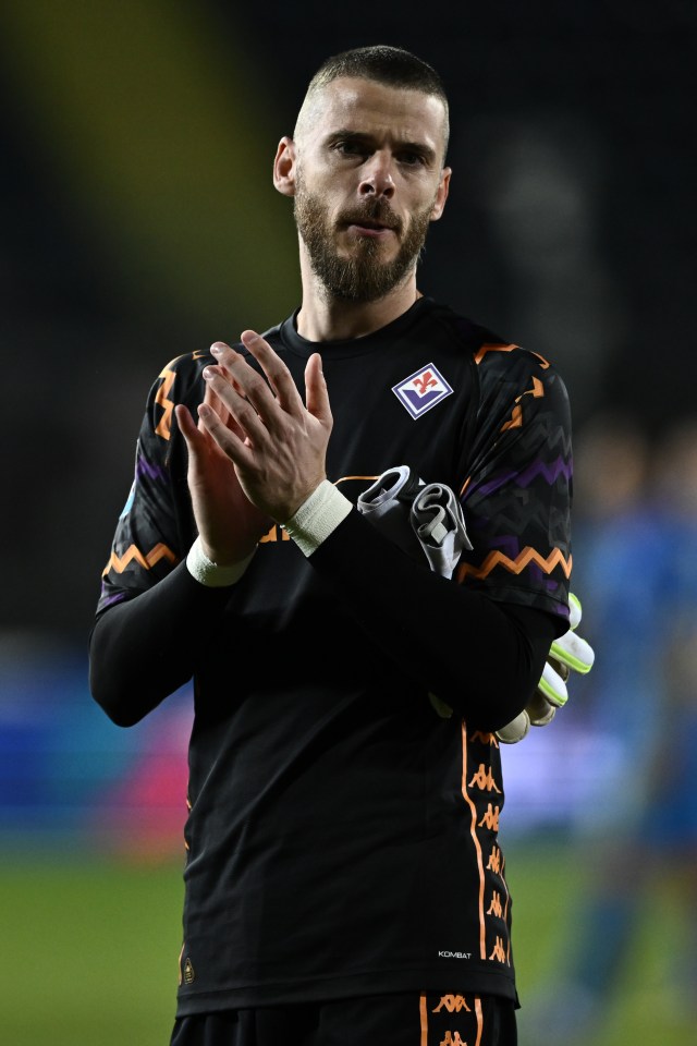 a man wearing a black kappa shirt applauds