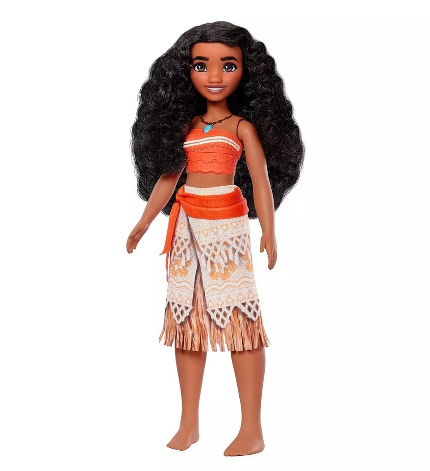 a doll with curly hair and a fringed skirt