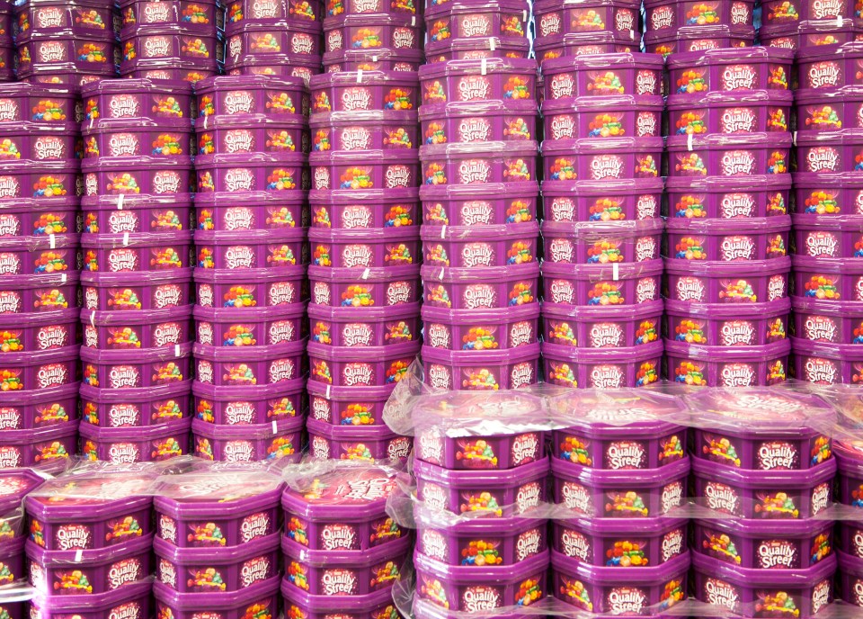 many purple containers of candy stripe are stacked on top of each other