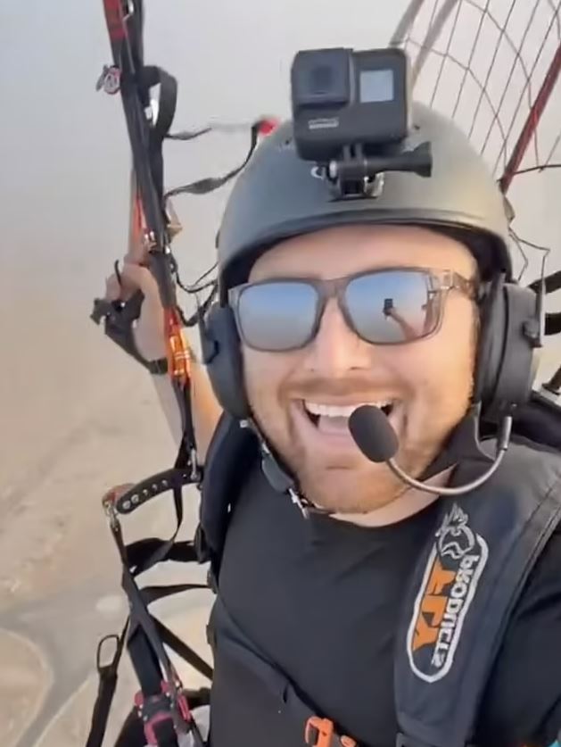 Paraglider Alex Lang soaring high above the pyramids in Egypt after seeing the dog