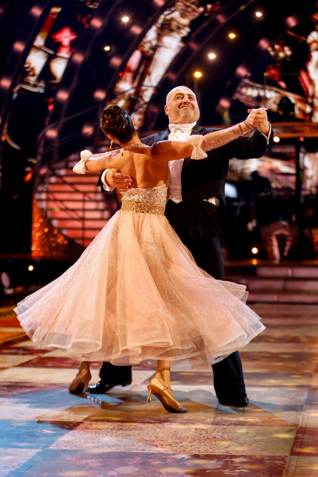 a man and a woman are dancing on a stage