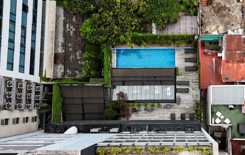 an aerial view of a swimming pool surrounded by buildings