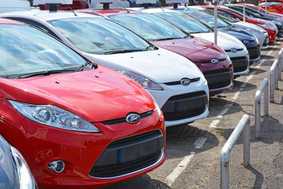 a row of ford cars are parked next to each other