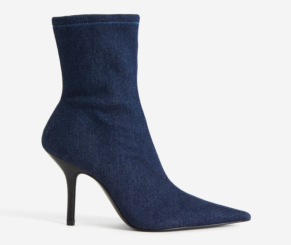 a pair of blue denim ankle boots with a black heel