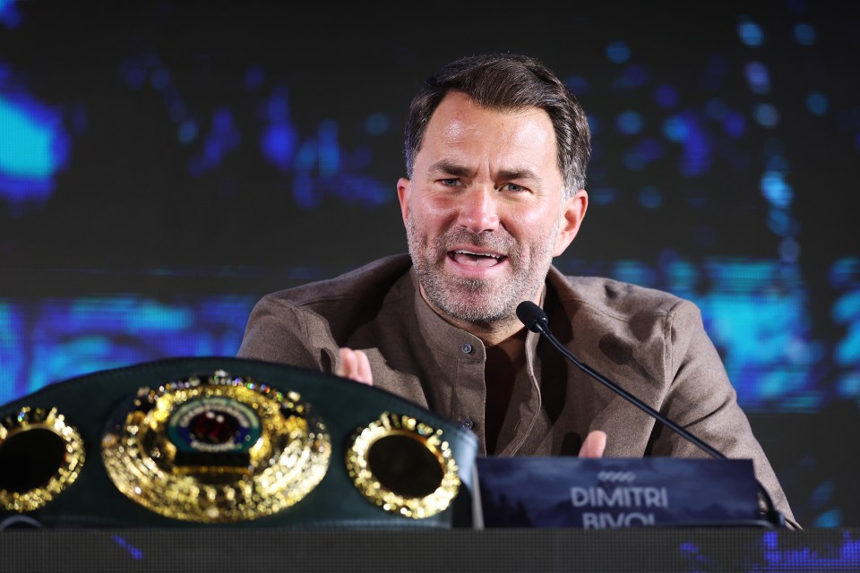 a man speaking into a microphone behind a sign that says dimitri riva