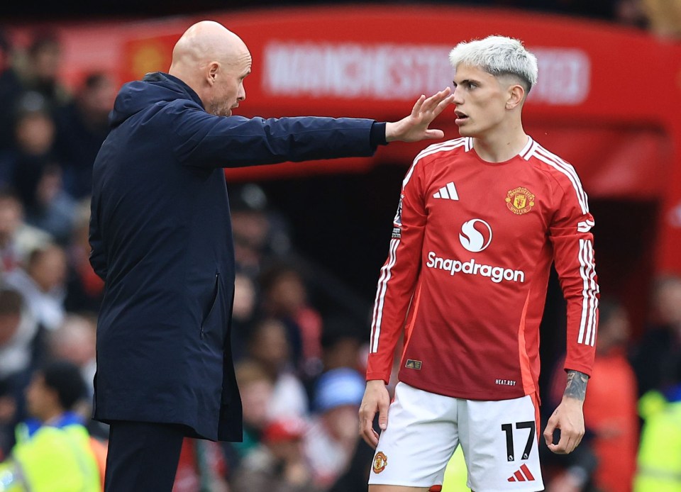 a soccer player wearing a snapdragon jersey talks to his coach