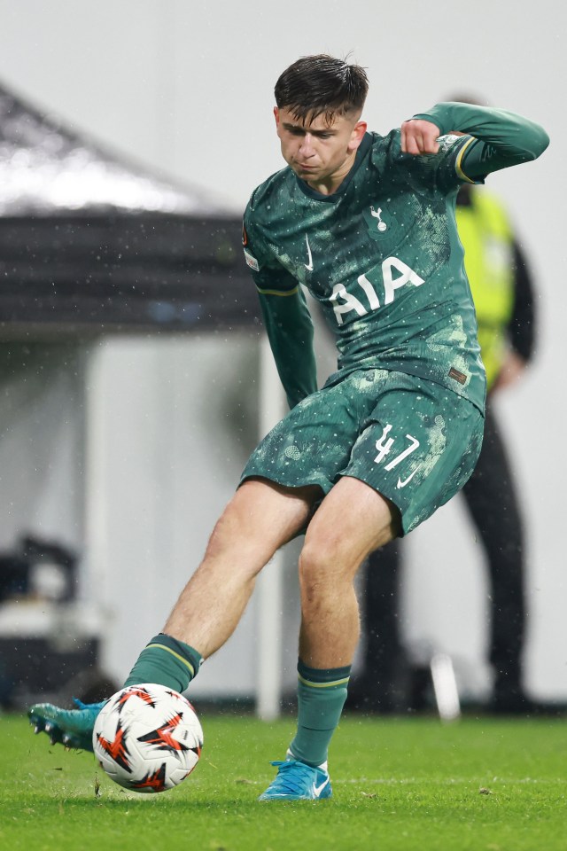 a soccer player in a green aia jersey runs with the ball