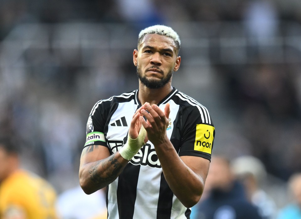 a soccer player wearing a black and white adidas jersey