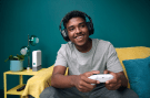 a man wearing headphones is playing a video game