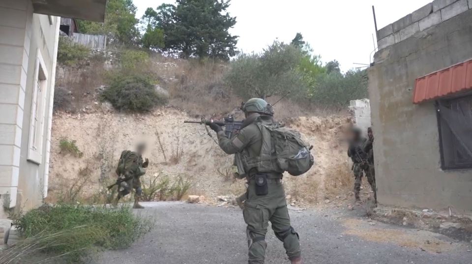 a soldier with a backpack is walking down a street