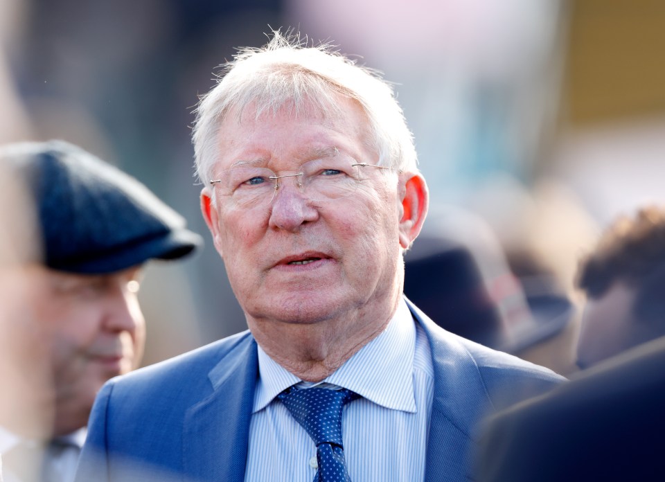 a man in a suit and tie stands in a crowd