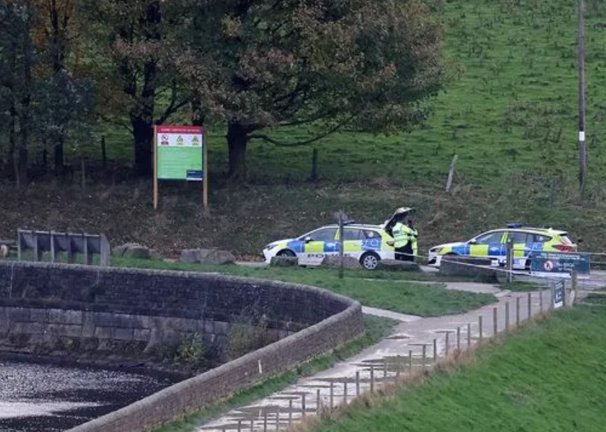 Police cars at the edge of the reservoir