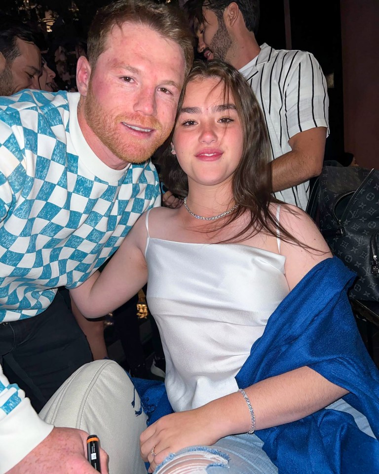 a man in a blue and white checkered shirt is sitting next to a woman in a white top