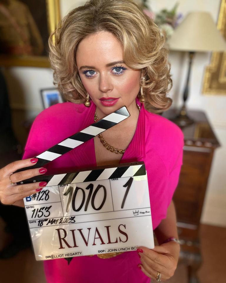 a woman holding a clapper board that says rivals