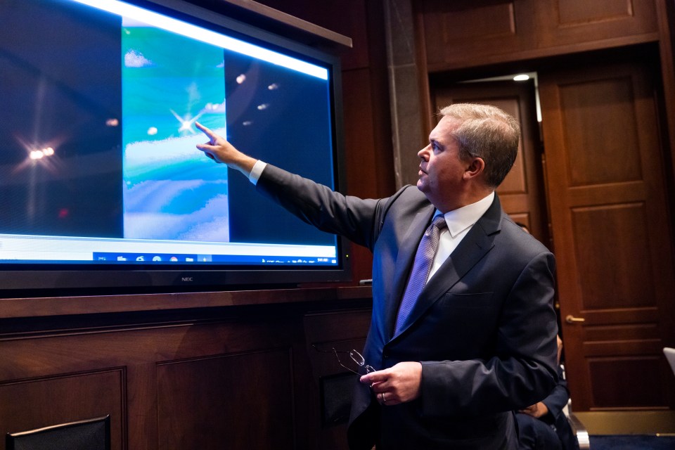 Deputy Director of Naval Intelligence Scott Bray plays a video of a UFO