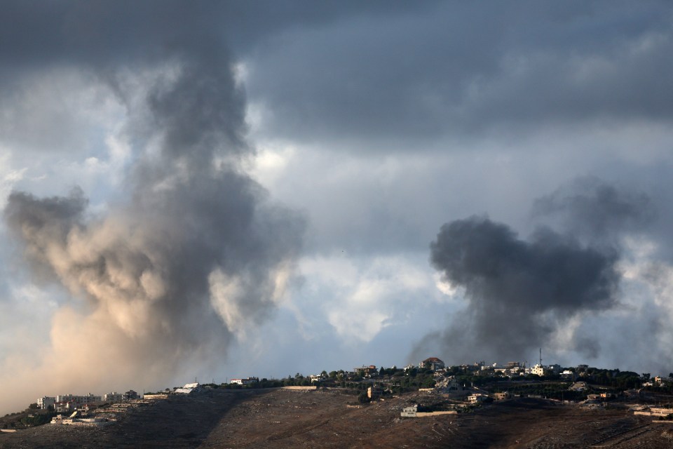 a cloudy sky with smoke coming out of the ground