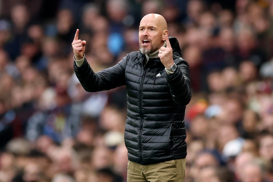 a bald man in a black adidas jacket giving a thumbs up