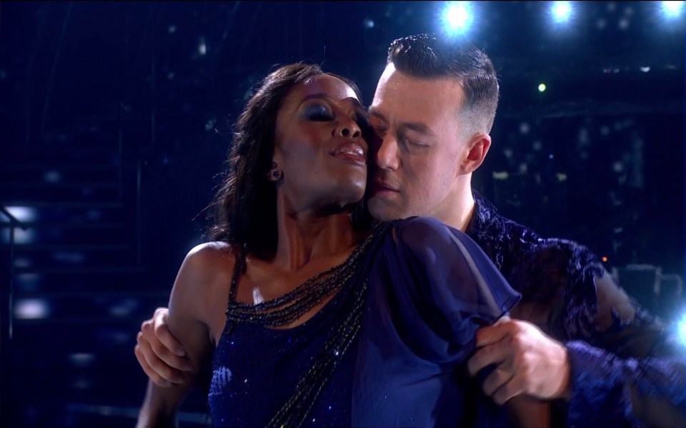 a man and a woman are dancing together on a stage