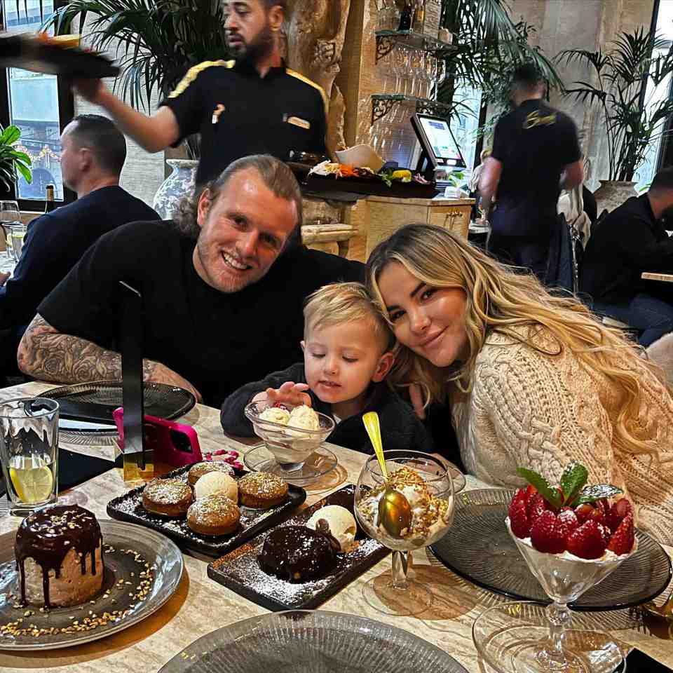 a family posing for a picture at a table with desserts