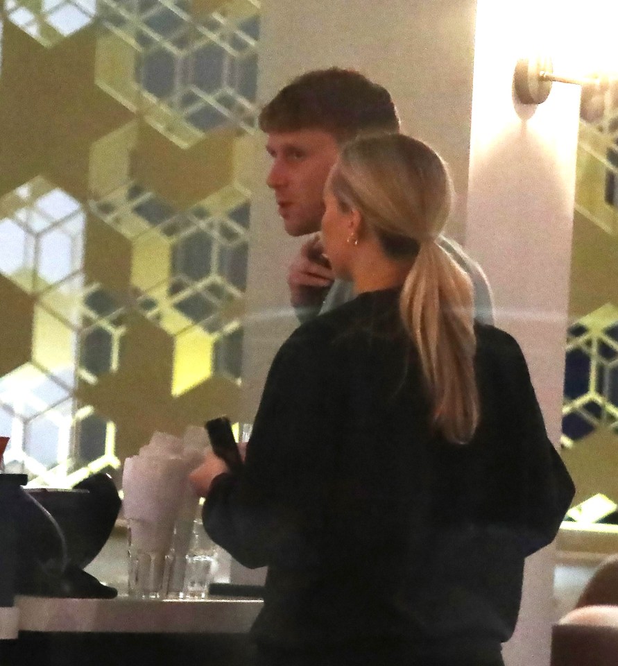 The soap star is seen ordering a drink at the bar alongside his companion