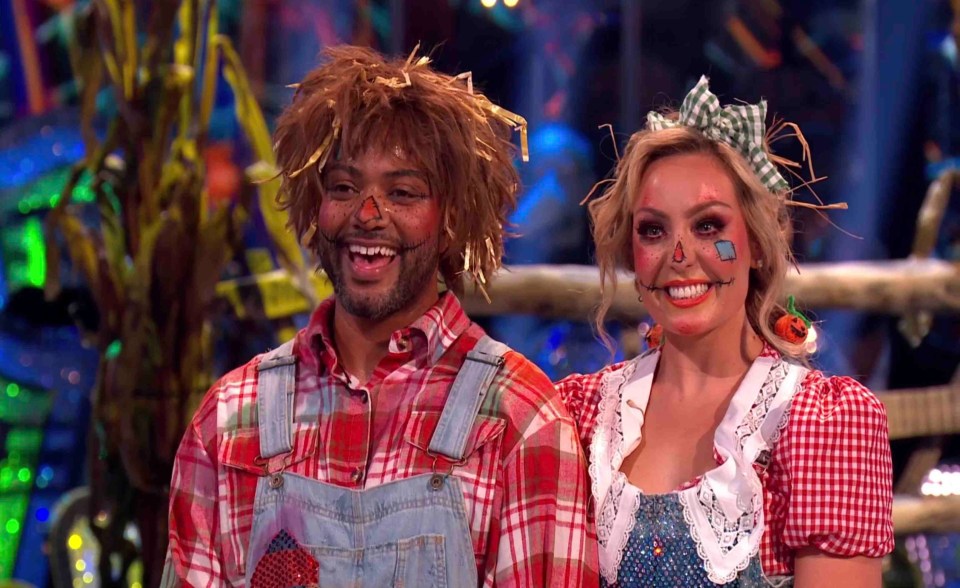 a man and a woman are dressed up as scarecrows