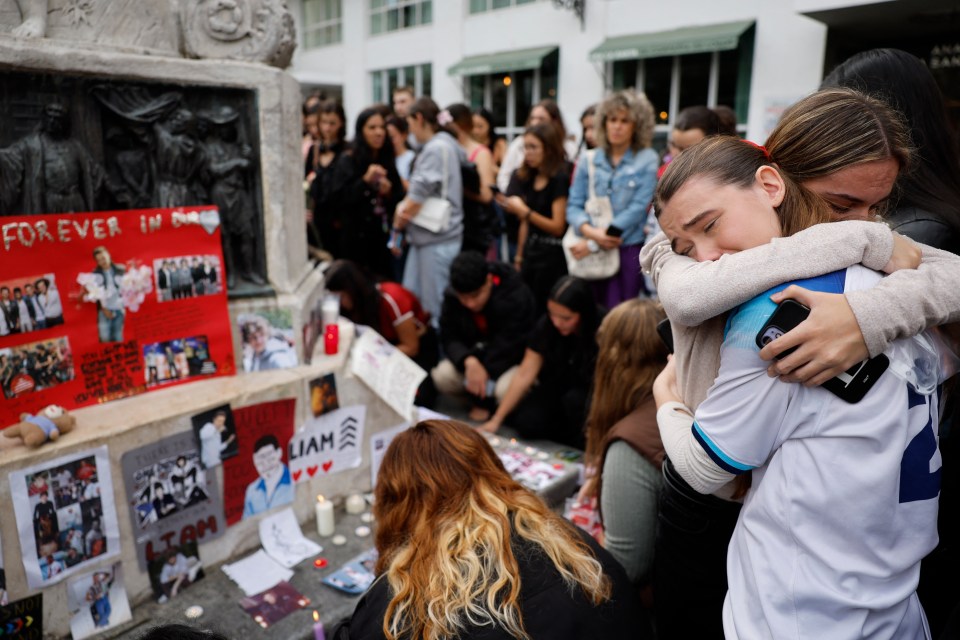 Supporters were seen hugging each other at a memorial in Madrid, Spain today