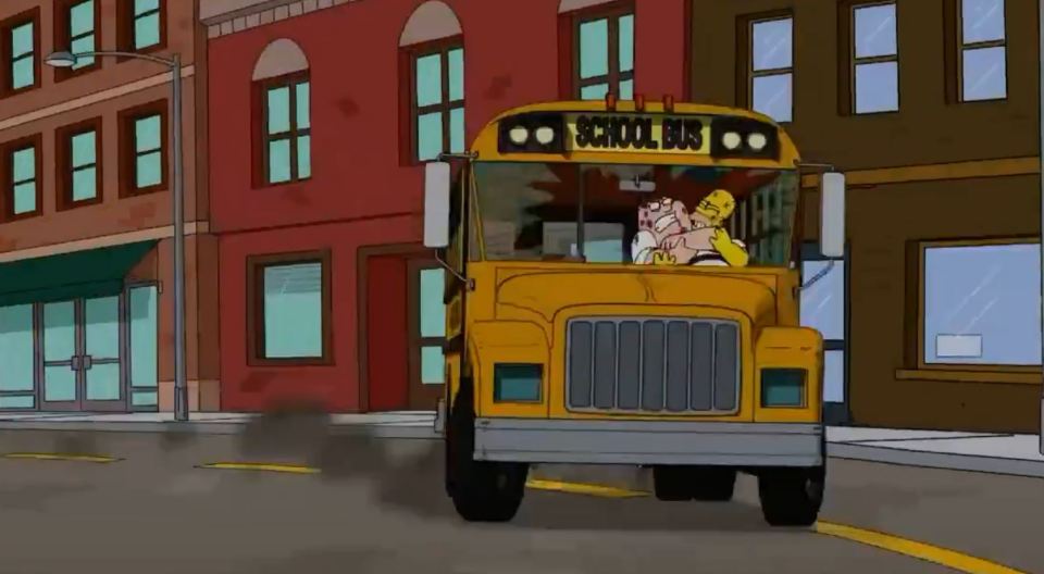 a yellow school bus is driving down a street